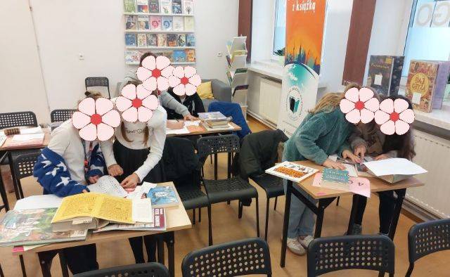 Biblioteczny escape room. Dzieci rozwiązują quizy w czasie zajęć z escape roomu.